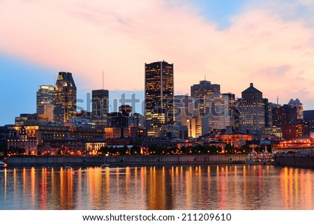 Montreal over river at sunset with city lights and urban buildings