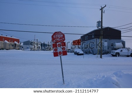 All way stop Sign with snow in the main cross road