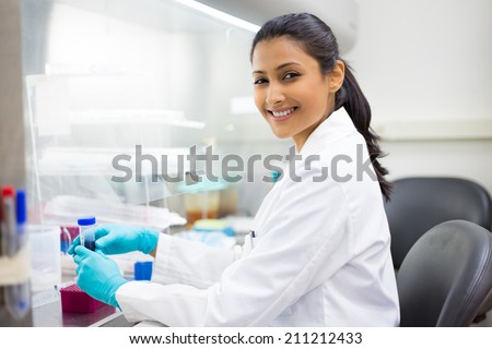 Closeup portrait, scientist holding 50 mL conical tube with blue liquid solution, laboratory experiments, isolated lab background. Forensics, genetics, microbiology, biochemistry Royalty-Free Stock Photo #211212433
