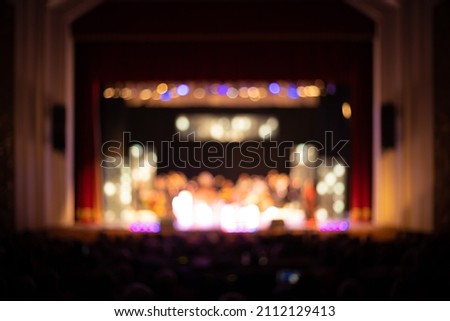Texture blur and defocus, background for design. Stage light at a concert show. Singers, musicians and dancers perform on scene.