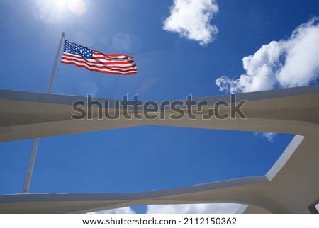 American flag on blue sky at Pearl Harbor monument