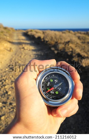 Orientation Concept a Male Hand Holding a Metal Compass