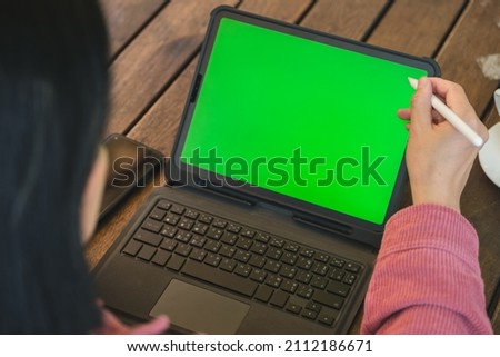 asian woman working with tablet green screen online at coffee shop