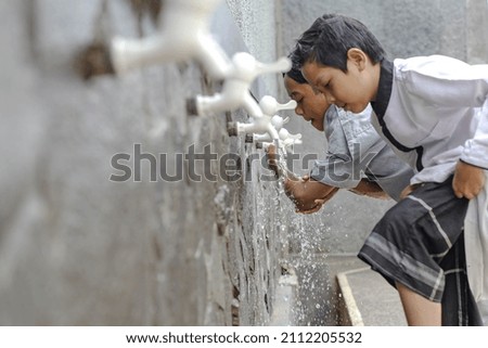 Close up An islamic boarding school students is doing ablution  Royalty-Free Stock Photo #2112205532