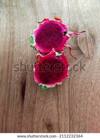 Dragon fruit slices on a wooden table