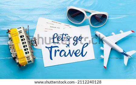 Travel and vacation concept. Trip accessories and items. Sunglasses, tram and airplane toy. Top view flat lay