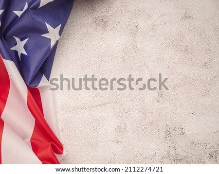 Top view of the American flag on a cement floor with copy space for text. Top view. Close-up photo.