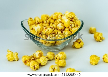 Popcorn in a plate on a white background. Selective focus. Sweet popcorn.