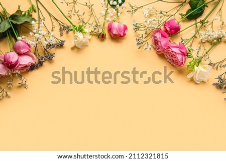 Composition with beautiful flowers on beige background