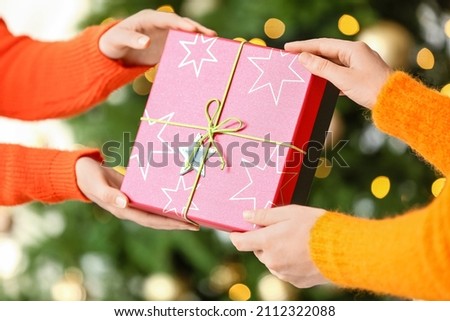 Women with gift box at home on Christmas eve, closeup