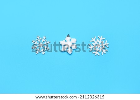 Beautiful composition with snowflakes on blue background