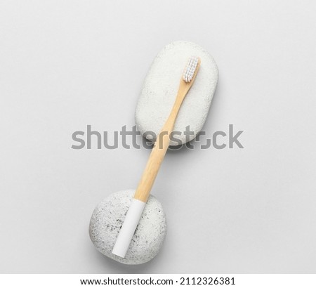 Wooden toothbrush on grey background