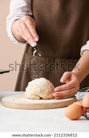 Woman preparing dough for homemade cookies at kitchen table, closeup Royalty-Free Stock Photo #2112336812
