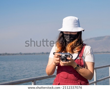 Portrait tourists women girl beautiful pretty girls Asian one people wearing white hat are taking pictures. with film camera hobby to record memory pictures of travel outdoor enjoy happy on vacation.