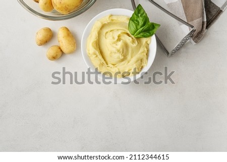 Composition with tasty mashed potatoes on light background Royalty-Free Stock Photo #2112344615