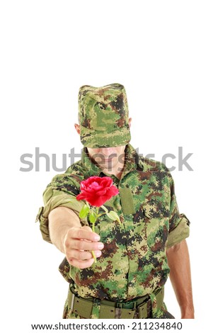 Romantic soldier in military uniform offering red rose, Make love not war