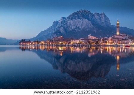 Colorful view of Lecco, Lombardy, reflecting on Como lake at blue hour, Italy Royalty-Free Stock Photo #2112351962