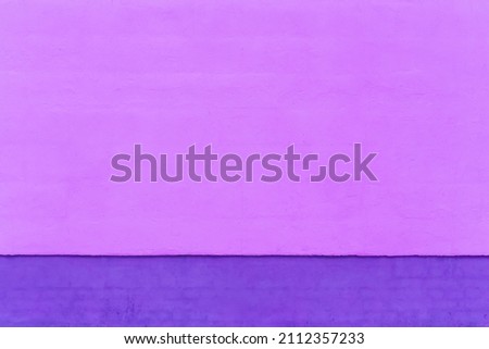 Pink and purple paint on the cement wall of the house art design background.