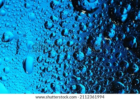 Macro texture of water drop on transparent surface