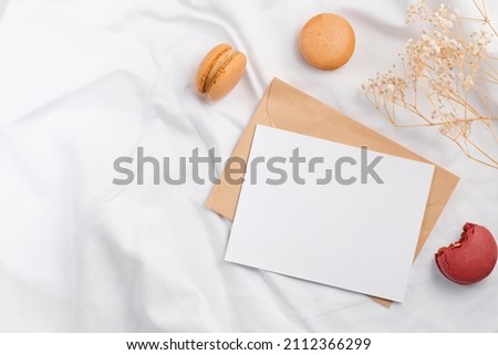 Colorful macarons and mockup letter on white textile, St. Valentines day concept