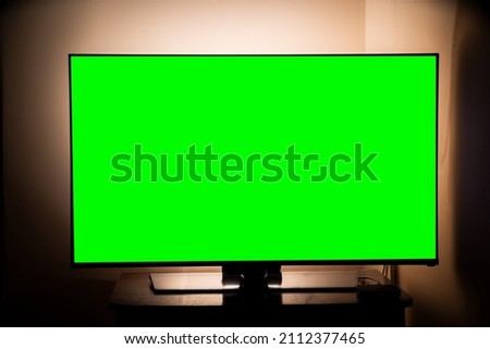 green screen tv in a dark room. Watching movies and TV series. online services. 