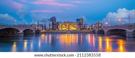 Downtown Des Moines city skyline cityscape of Iowa and public park in USA at sunset