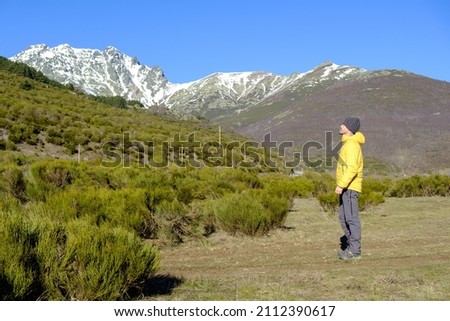 A man observes the snow-capped mountains in winter. Health and energy in nature