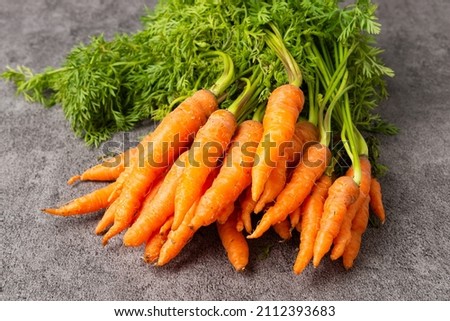 Close up pile of fresh Baby carrots on stone background