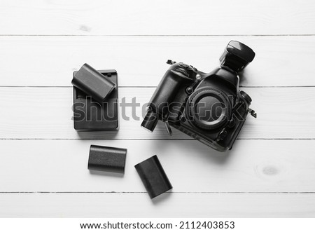 Photo equipment on white wooden background, top view