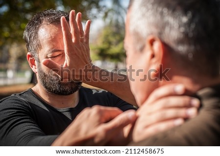 Two men quarrel and fight. Kapap instructors demonstrates street fighting techniques. Training demonstration Royalty-Free Stock Photo #2112458675