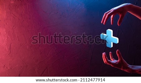 Businessman hold 3D plus icon, man hold in hand offer positive thing such as profit, benefits, development, CSR represented by plus sign.The hand shows the plus sign.