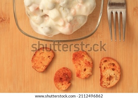 Traditional Russian salad Olivier in a Bowl Top View, White Background, Popular Russian Food Horizontal Directly Above Stock Photo