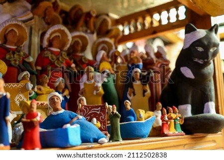 Handmade clay dolls of miniature folk musicians in traditional Moroccan clothes with a musical instruments and clay animals at the market in Taroudant , Morocco.