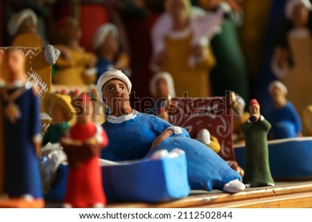 Handmade clay dolls of miniature folk musicians in traditional Moroccan clothes with a musical instruments and clay animals at the market in Taroudant , Morocco.