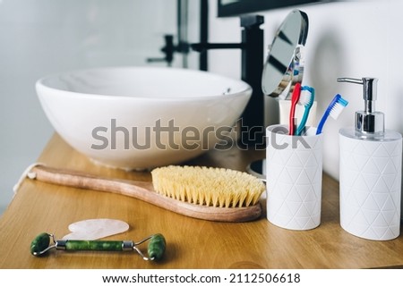 cosmetic products for body and face care in the bathroom. gouache scraper, massage brush, jade roller, toothbrushes. High quality photo