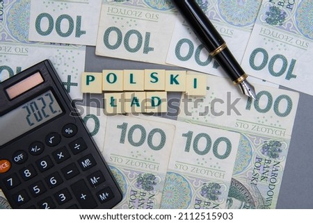 Sentence Polski Ład which means "Polish Order" at the background of the polish money. Concept of the biggest tax reform in poland and problems with it Royalty-Free Stock Photo #2112515903