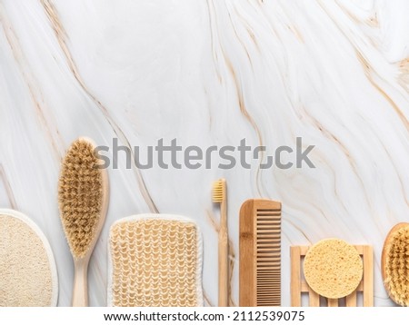 Eco products for massage and spa flatlay on light marble background. Skin care accessories creative relax concept., top view, copy space. Brushes and sponges