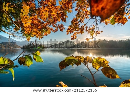 The famous Alpine Lake Bled (Blejsko jezero) in Slovenia, an amazing autumn landscape. Fabulous view of the lake, island with church, Bled Castle, mountains and blue sky with clouds, backdrop in the