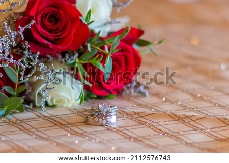 Wedding rings displayed with flower bouquet