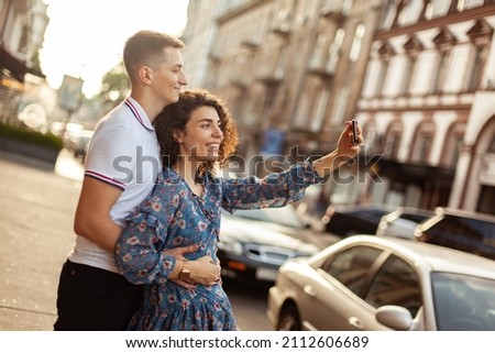 Young lover spends time together, taking selfie in city