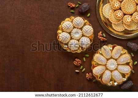 Assorted semolina maamoul or mamoul cookies with dates , walnuts and pistachio nuts. Traditional arabic Eid al Adha, Eid al Fitr sweets . Top view, flat lay Royalty-Free Stock Photo #2112612677