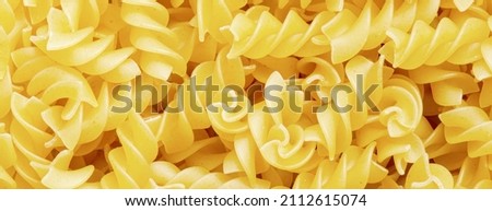 Raw fusilli pasta. Food background. An ingredient for traditional Italian food. Closeup