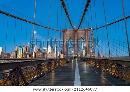 Night Picture of the Brooklyn Bridge With Full Moon over Manhattan in the background