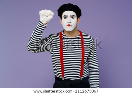 Strict nervous displeased irritated sad concerned young mime man with white face mask wears striped shirt beret making knocking gesture isolated on plain pastel light violet background studio portrait