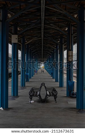 Symmetry in a train station Royalty-Free Stock Photo #2112673631
