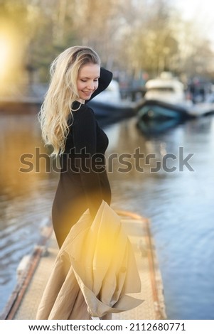 young blond slavic woman with long hair closeup street portrait with glasses on marina boat background