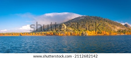 Beautiful autumn landscape. Borovoe lake and stone sculpture Jumbaktas, Burabay National park in Northern Kazakhstan.
