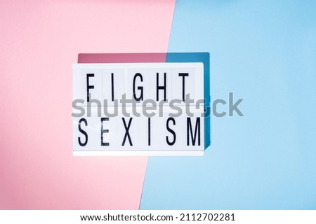 Fight sexism text on the lightbox. Feminism concept. Top view.