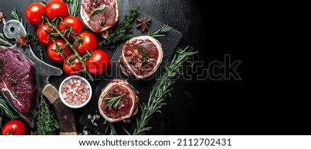 Variety of raw beef meat steaks for grilling with seasoning on over meat butcher knife. banner, menu recipe top view.