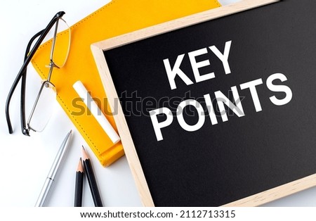 KEY POINTS text on blackboard with notepad , pen, pencil